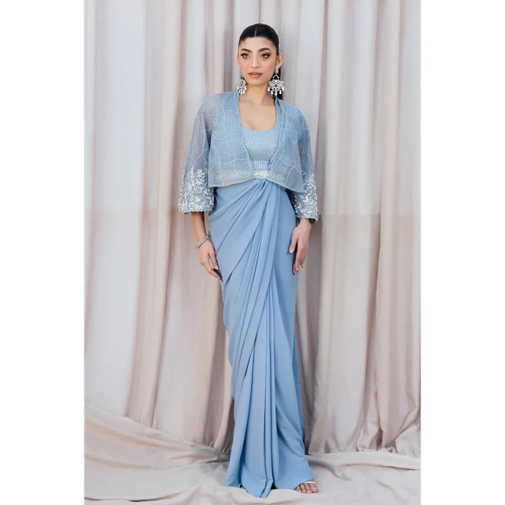 Occasion Styling "Sky Blue Fusion Saree styled for a wedding guest look, combining traditional embroidery and modern elements like the belt and organza cape."