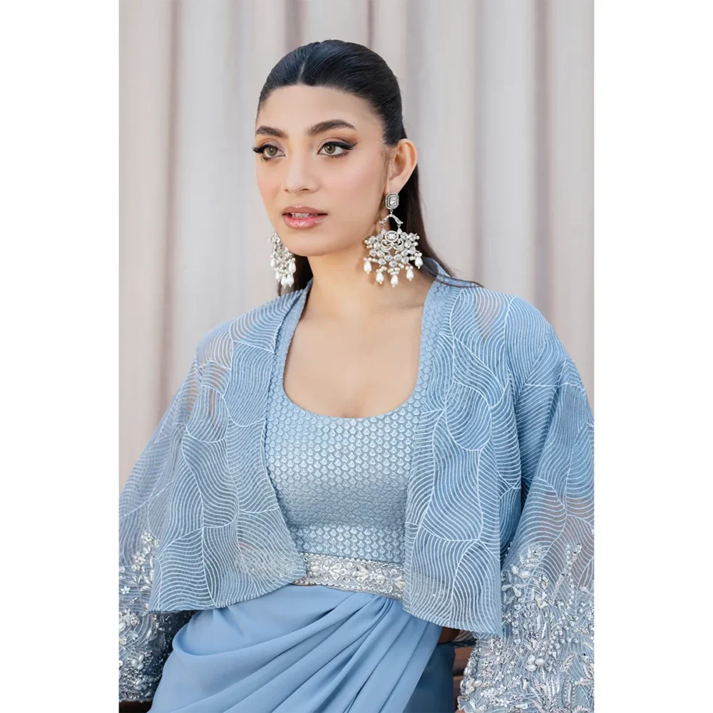 Close-up of Saree Embroidery "Intricate embroidery on the sky blue fusion saree, showcasing handcrafted craftsmanship with pearl and silver embellishments."