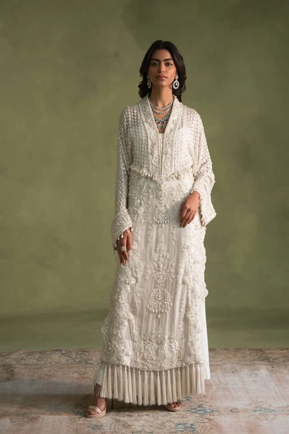 White dress with pearl embellishments and flared sleeves