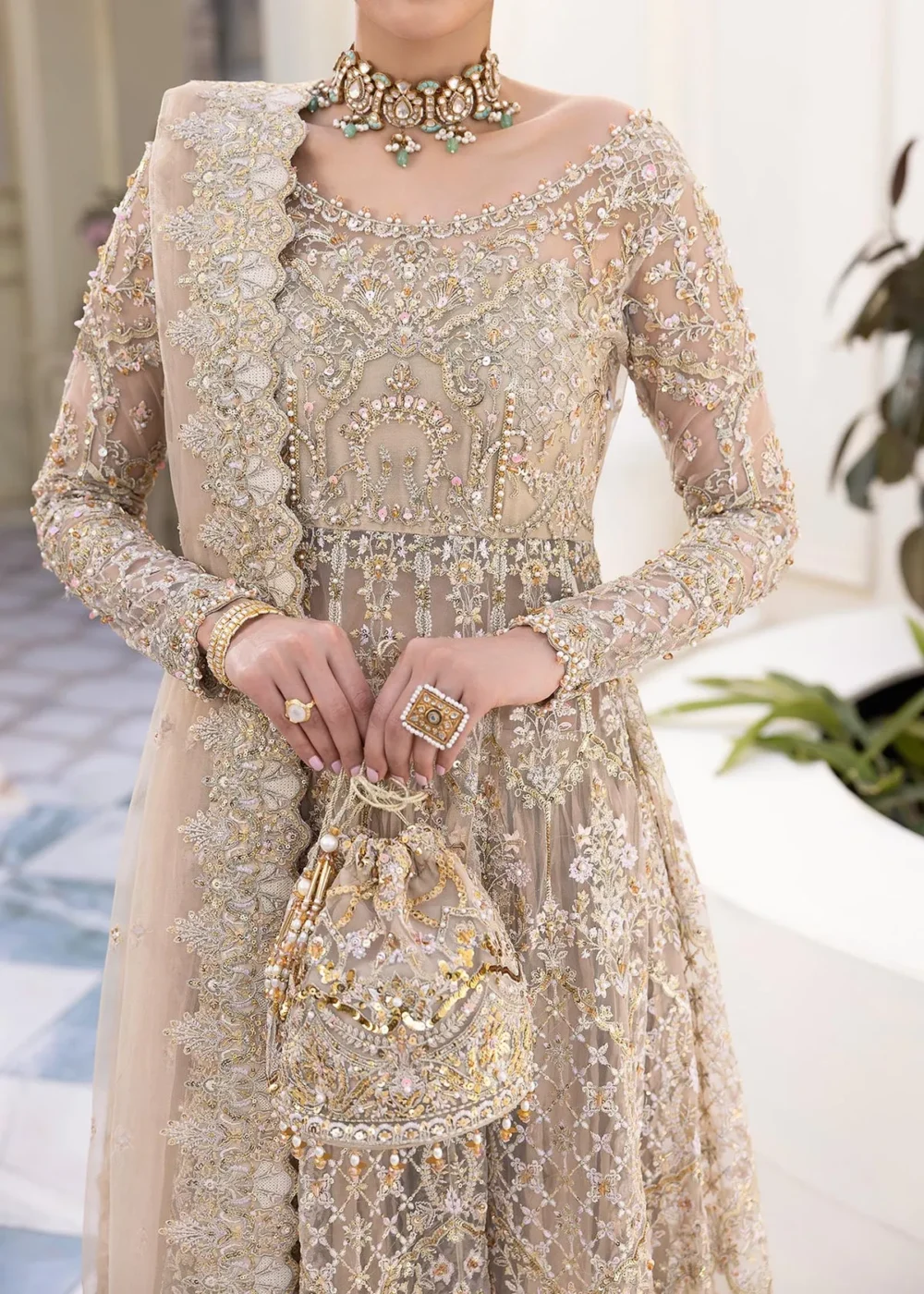 Nude Peshwas ensemble with delicate embroidery and shimmering embellishments