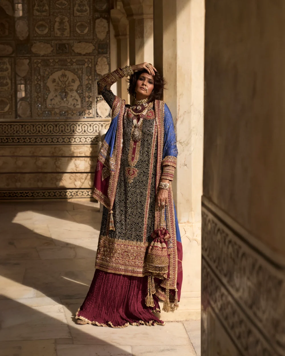 The Black Charmeuse Chunri Lehenga Set is highlighted with its exquisite craftsmanship and luxurious fabric.