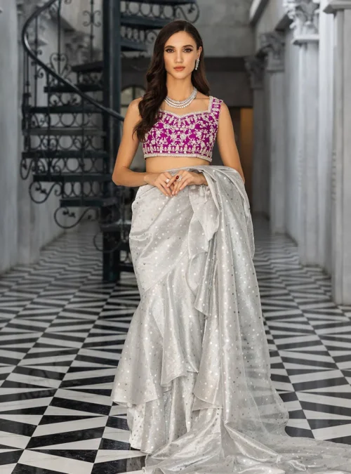 Silver Embellished Saree showcasing the extravagantly draped silhouette and the vibrant magenta blouse.
